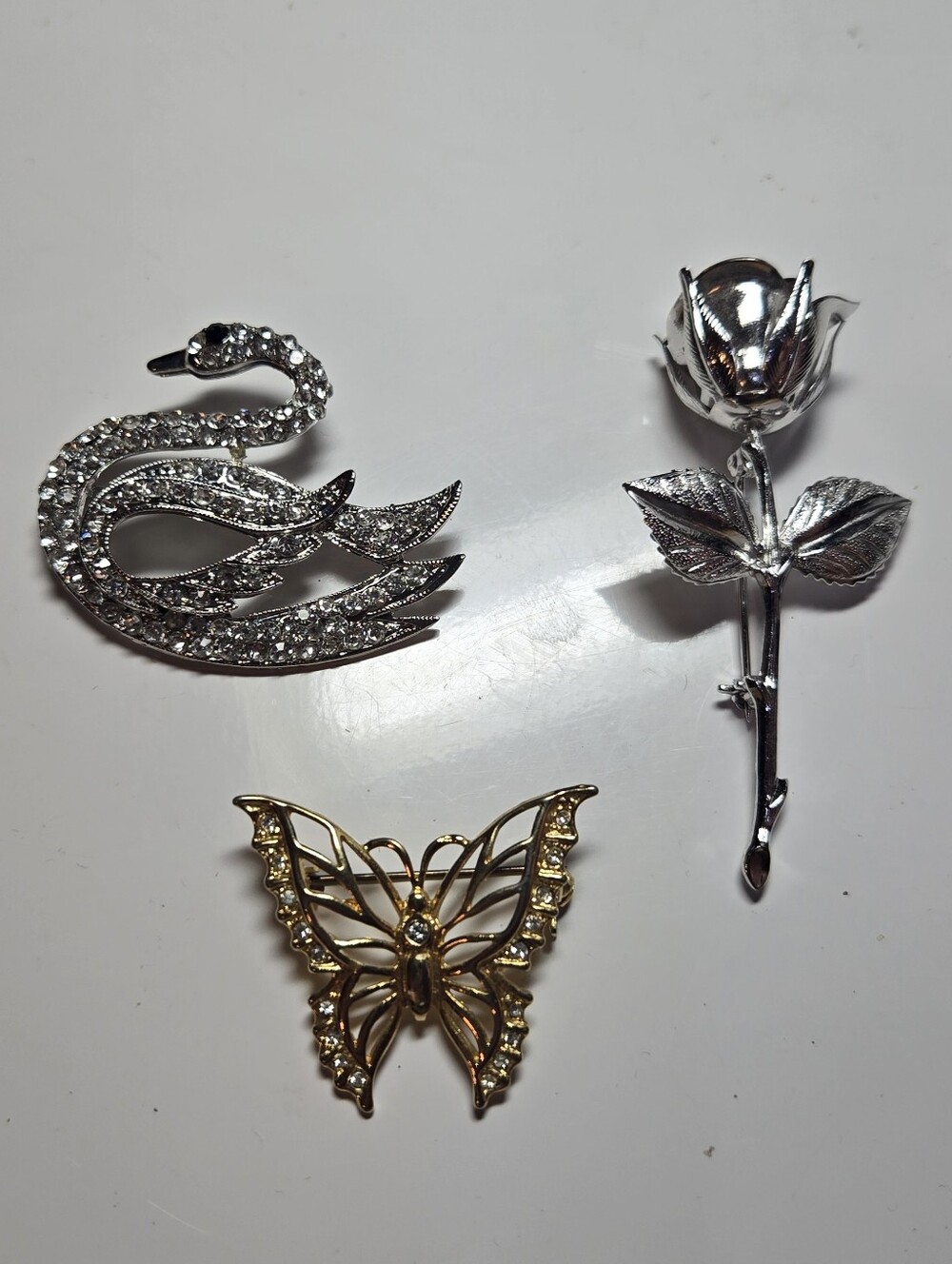 Butterfly, Rose And Swan Brooches
